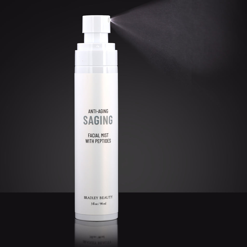 Anti-Aging Saging in White Spray Mist Bottle Showing Fine Mist Spray Against a Black Background