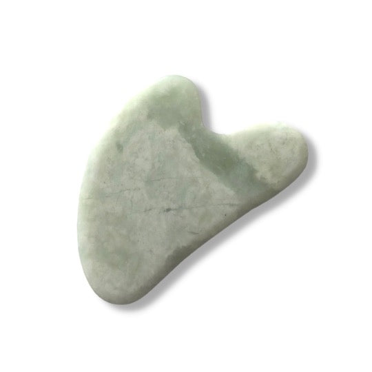 Serpentine stone shaped into an ergonomic facial massaging tool, featuring a curved V shape on the wide end for contouring the jawline.