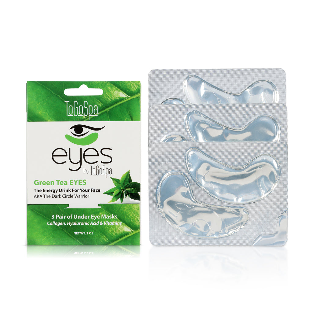 Green Tea Eye Masks Paper Packaging Next to Three Eye Masks Collated Together.