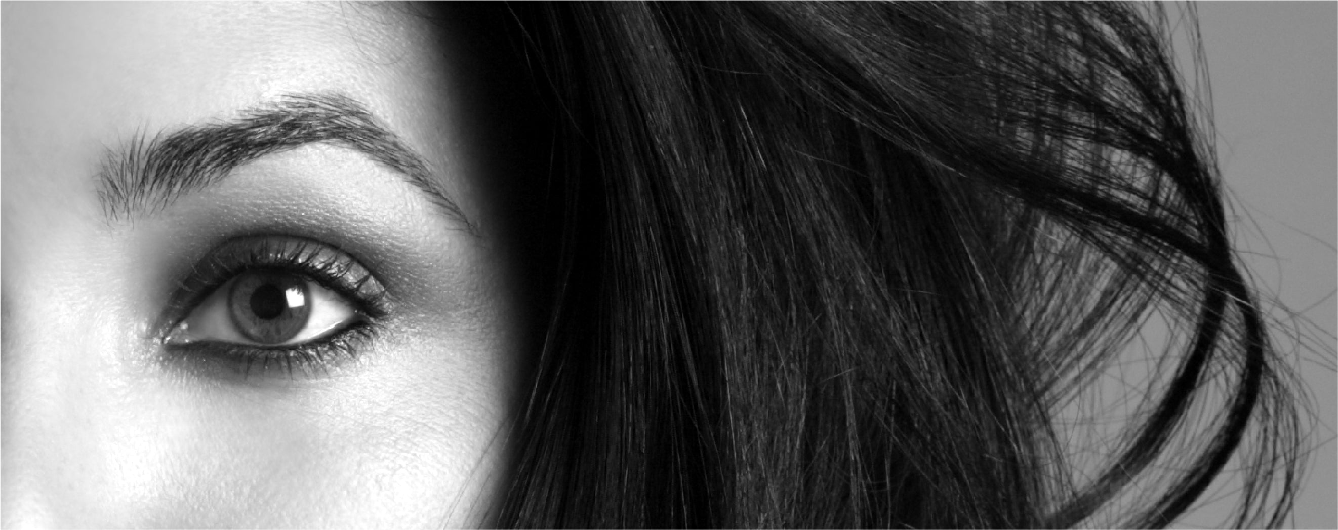 Image features a closeup of a woman's eye and shaped eyebrow.