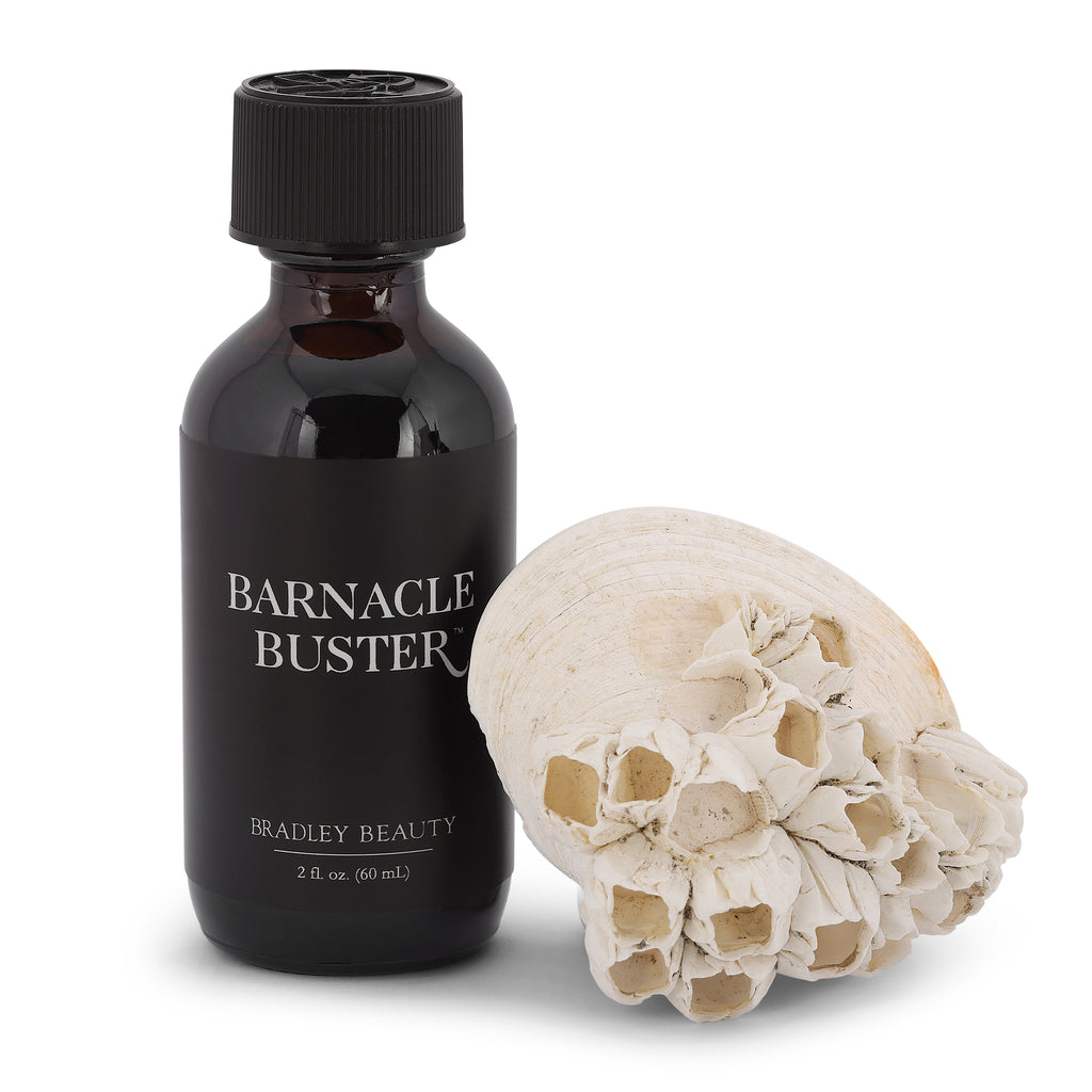 Barnacle Buster Facial Tonic Product Standing Next to Seashell Encrusted with Fossilized Barnacles