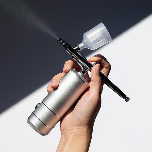 Ionized Oxygen Infuser held in a hand dispensing serum into a fine mist.