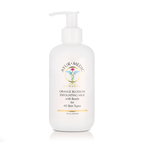 Orange Blosson Exfoliating Milk in white bottle with pump dispensing cap.